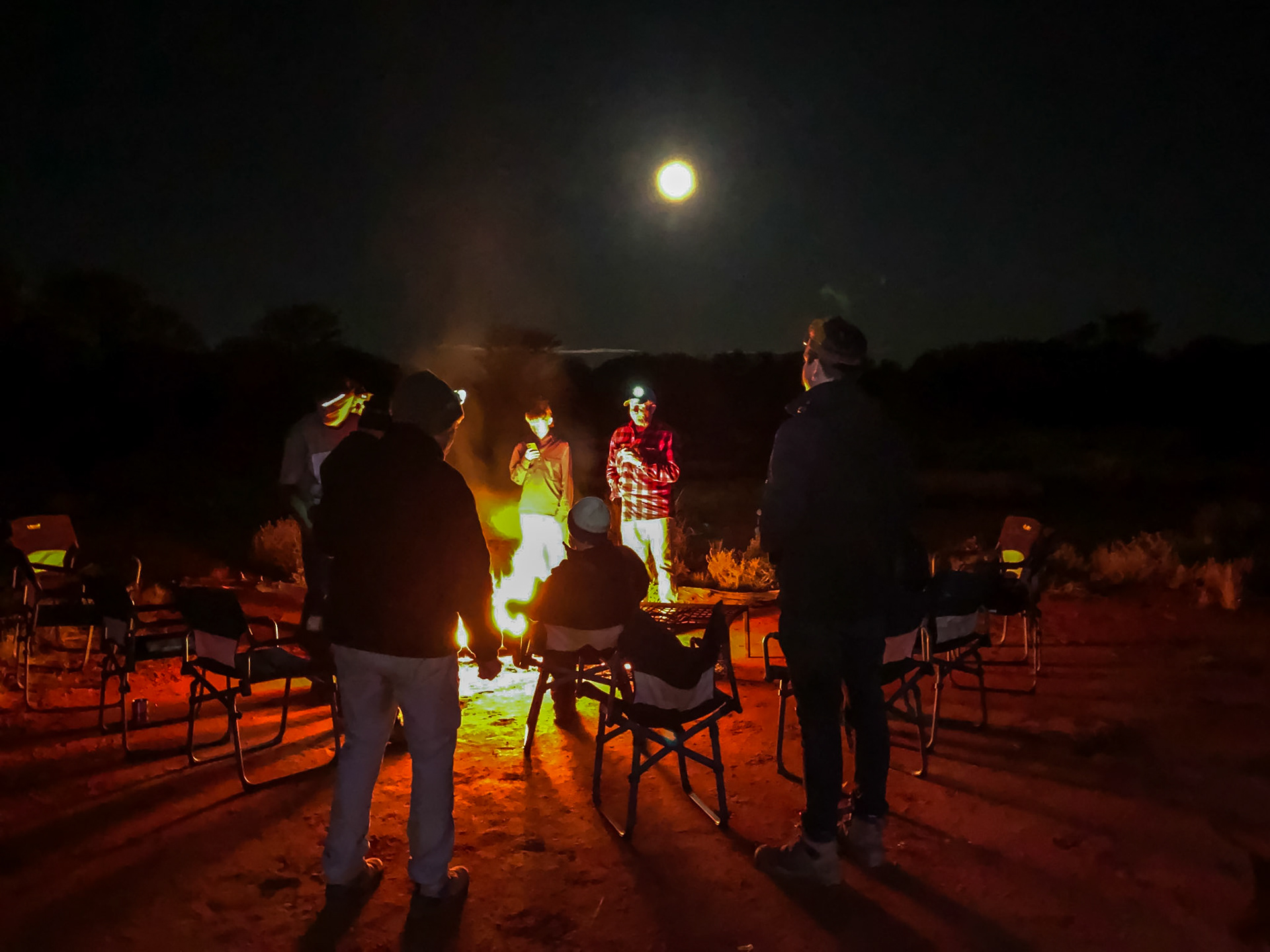 Around the campfire, with full moon. Final night.