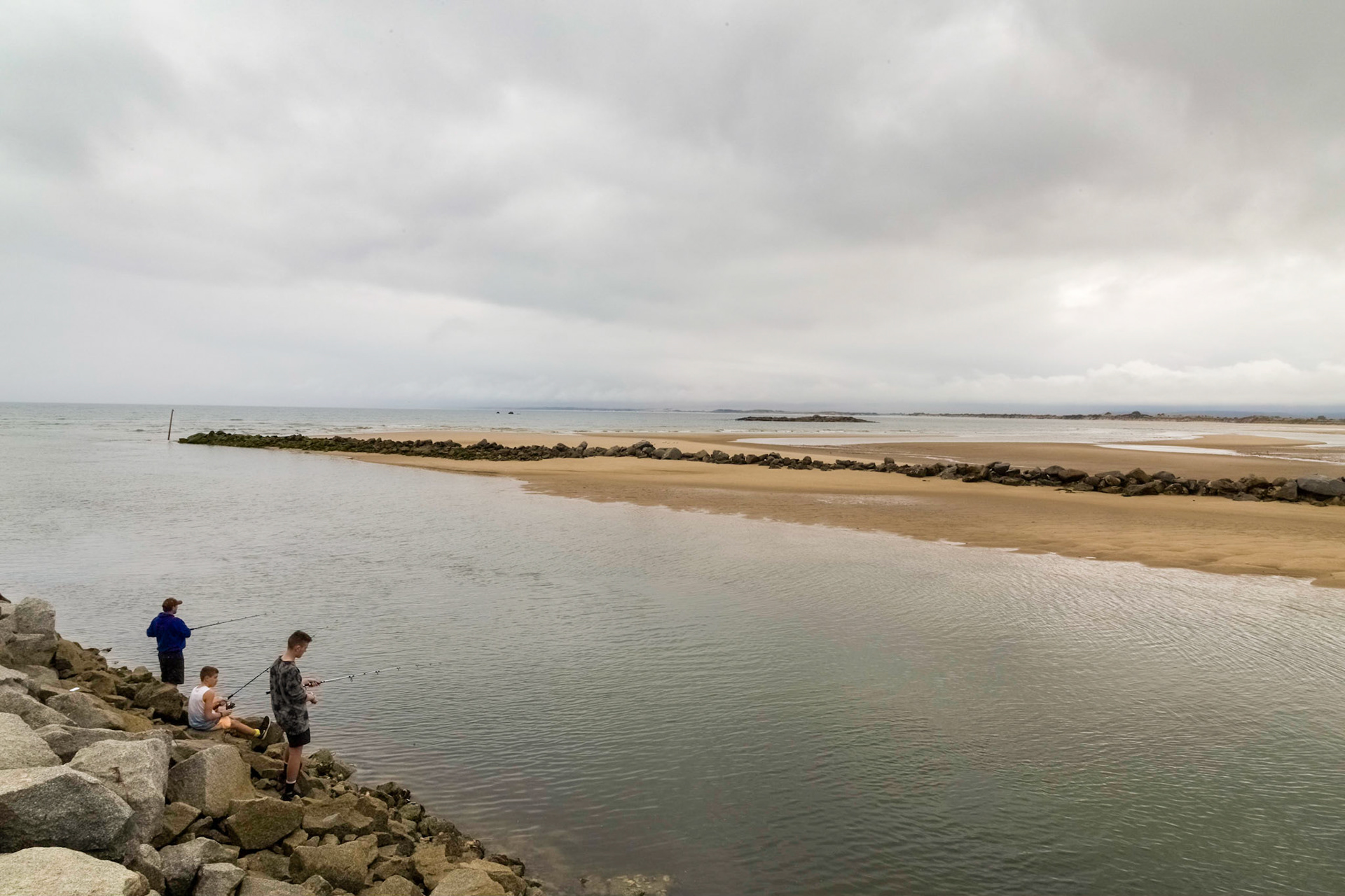 Boys fishing at the mouth of the Brid River, Bridport