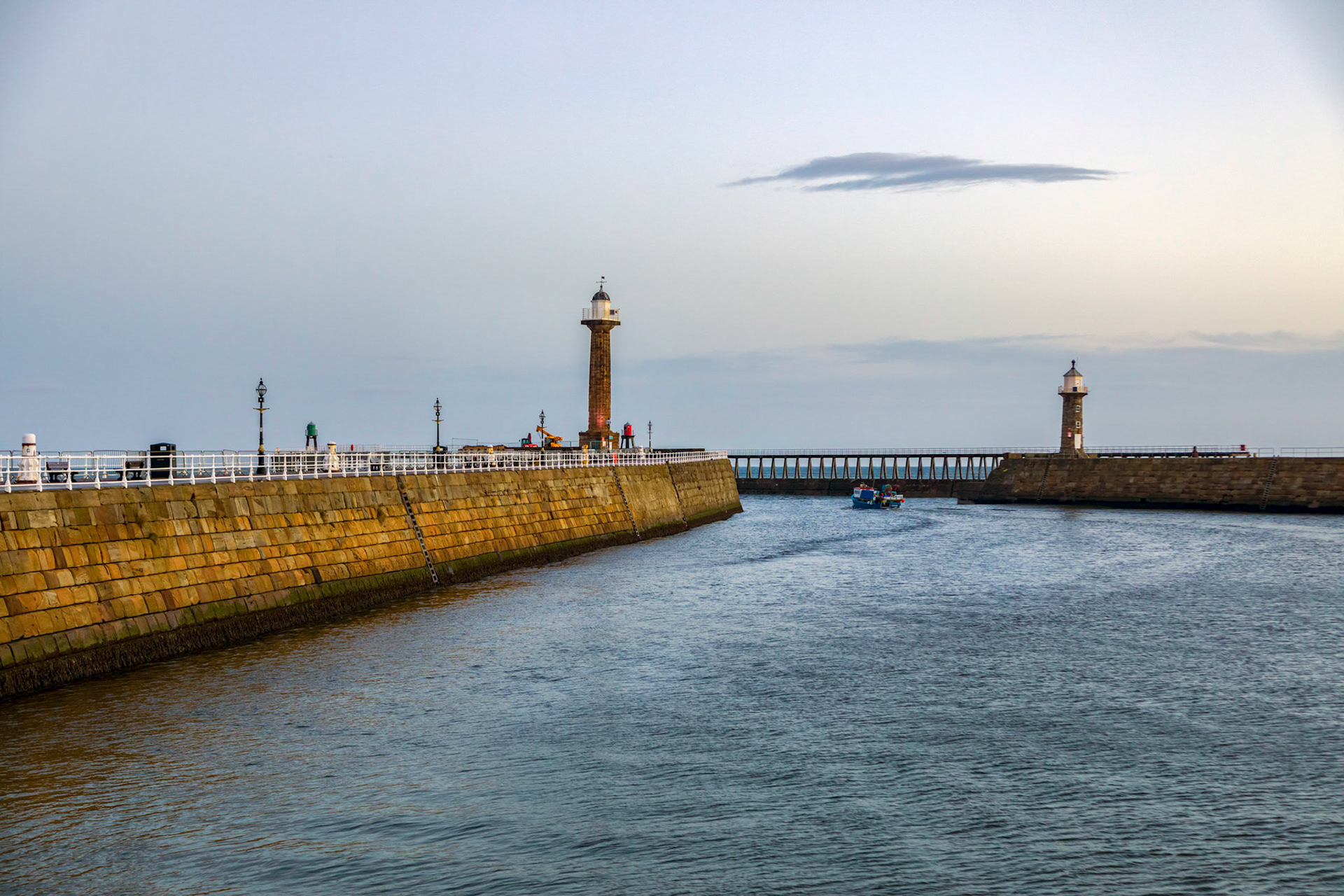 Fishing boat leaving the safe harbour at dawn, from Whitby.