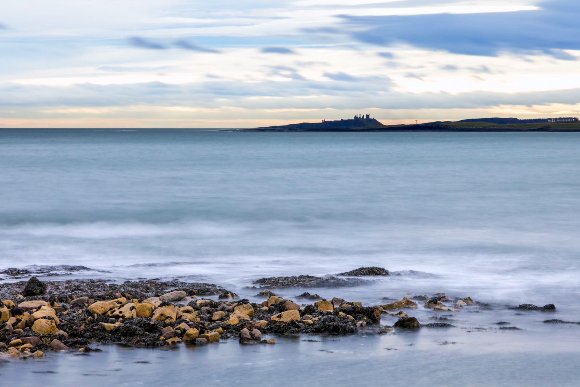 Distant Dunstanburgh Castle, Beadnell Bay