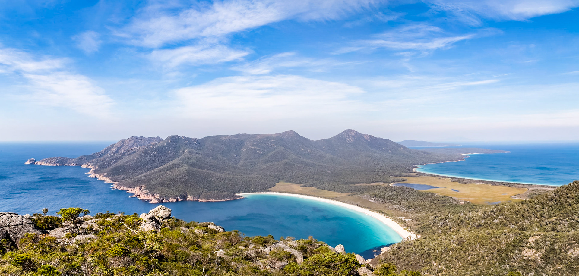 Wineglass Beach and the Bay, from the summit of Mt Amos (454m). With Hazards Beach and Promise Bay on the other side of the isthmus, with Mt Graham (579m) and Mt Freycinet (620m) behind.