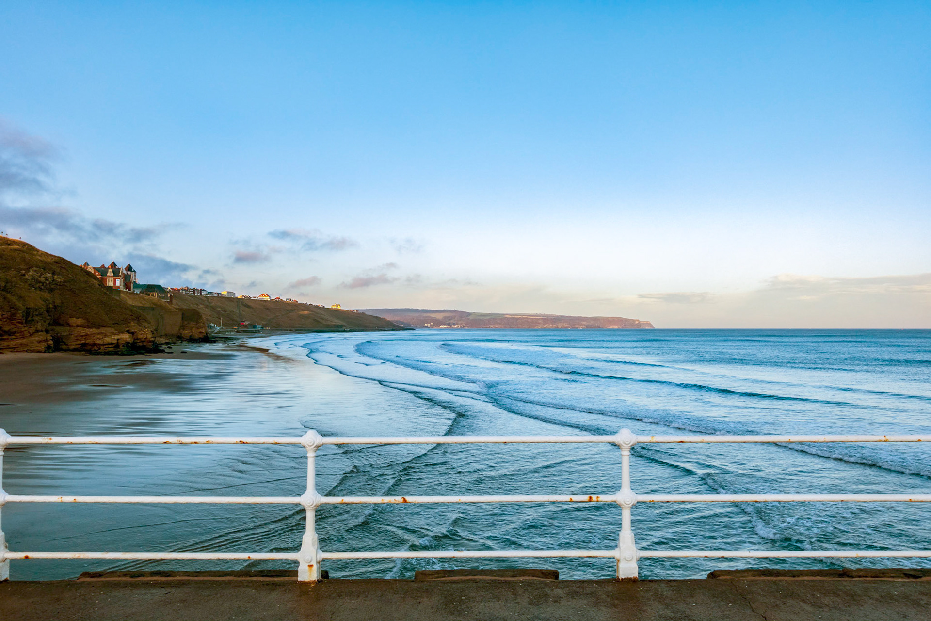 The view up the coast to the west after sunrise at Whitby