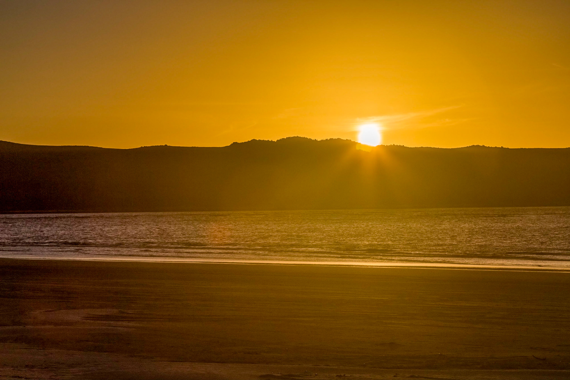 Watching from the beach the sun set over Macquarie Heads. With Strahan ATV Adventures