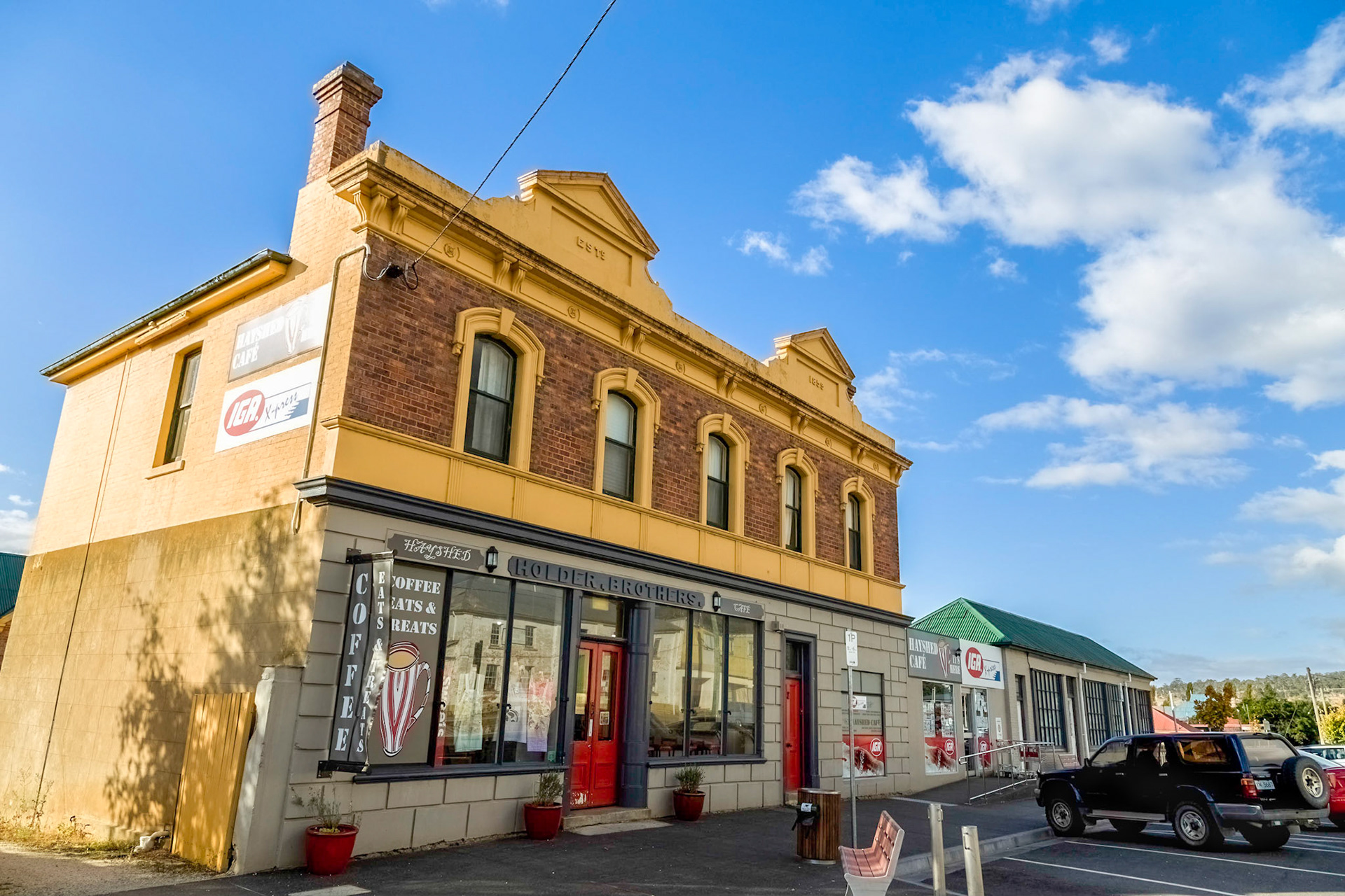 Fingal. Holder Brother's Store (1859). Established originally as a one storey stone house, later a three storey house and stable were built (1885) and then a top storey of seven rooms added later (1894). Now a part of the town's IGA supermarket.