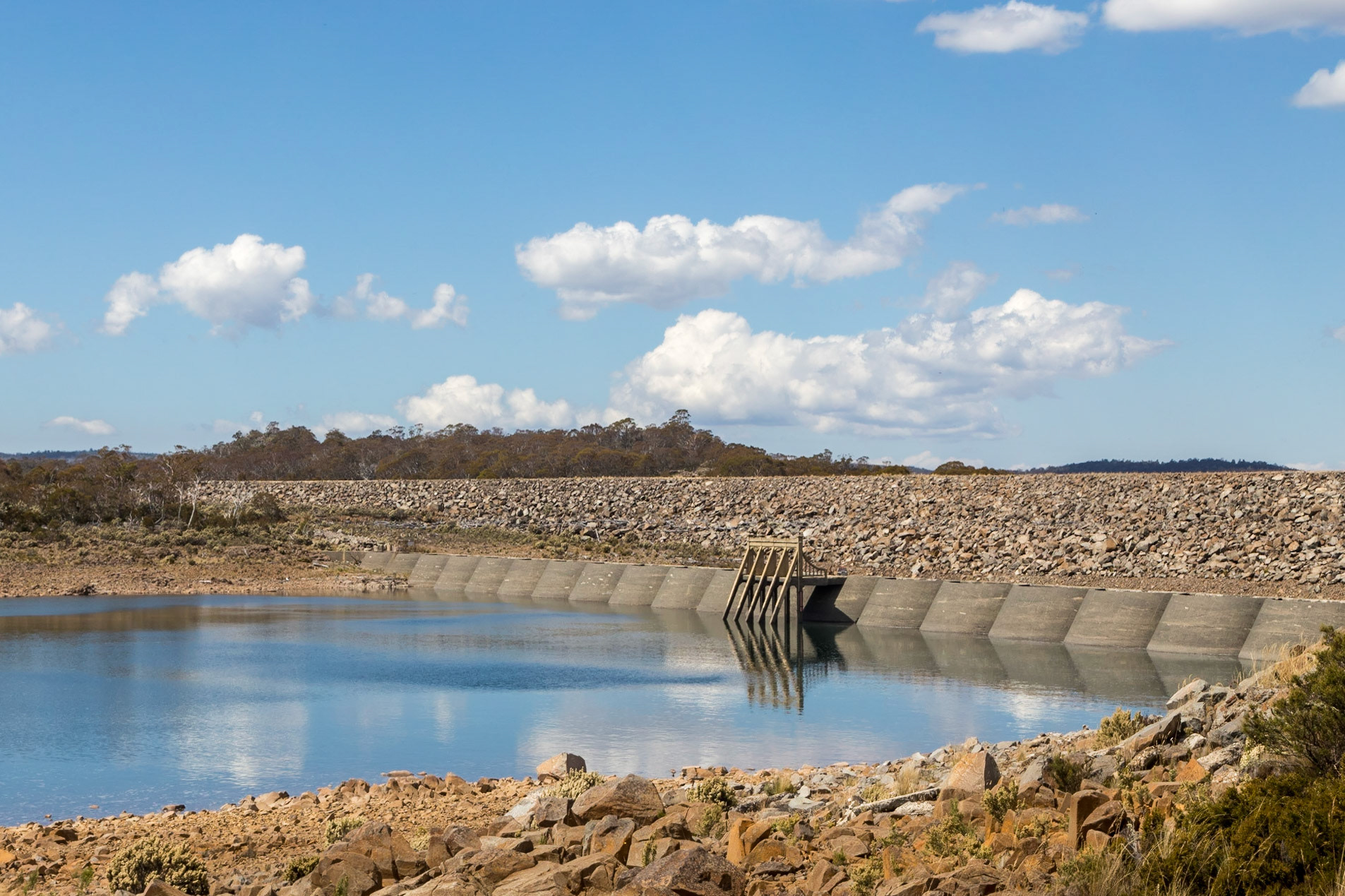 Great Lake - Miena Dams. Three levels of dam wall are visible; the first from 1916, then the second of 1922 with 27 concrete arches supported by concrete butresses, then the third being a 22m high rockfill dam raised a further 6 m in 1962.