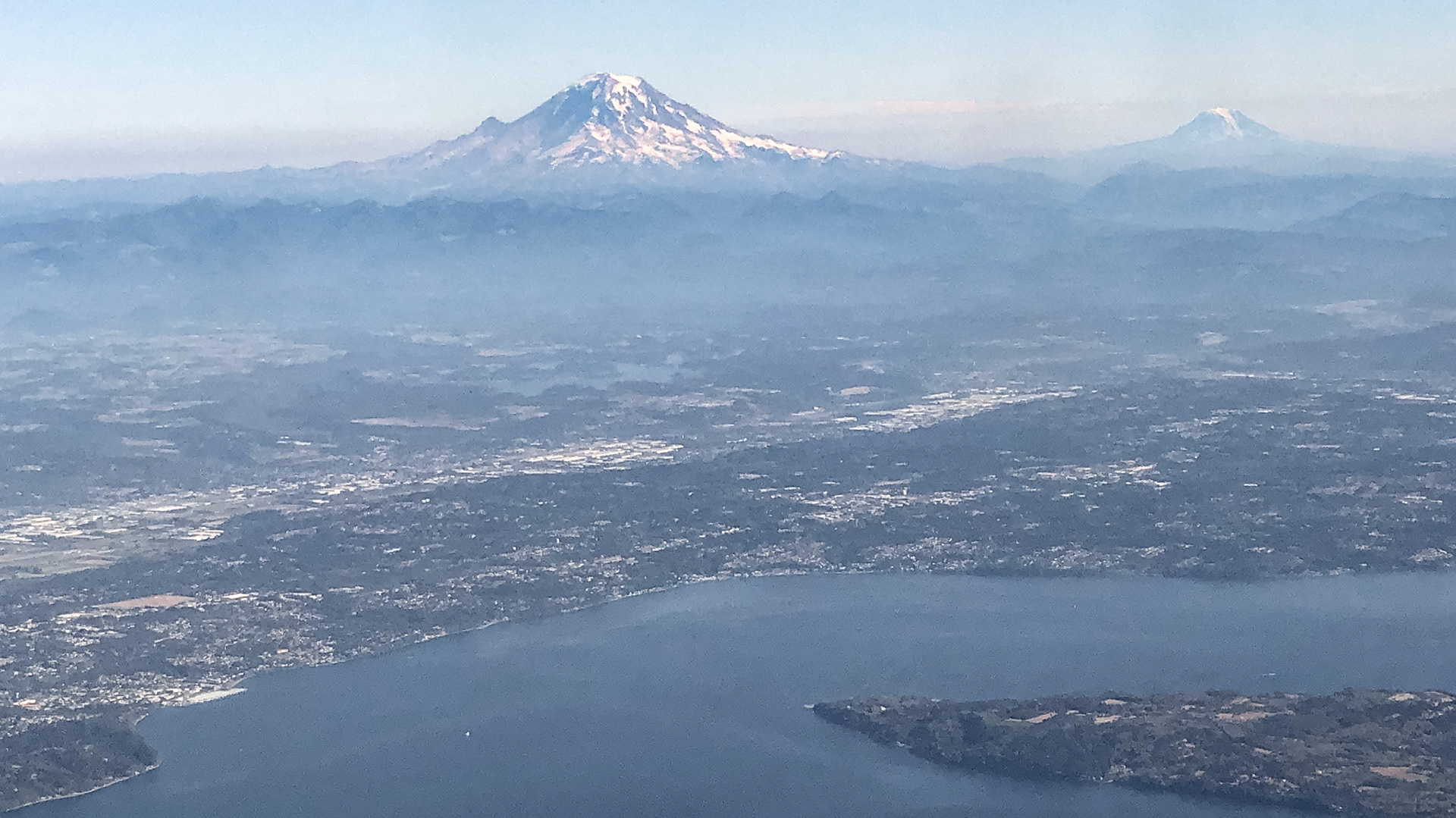 Imposing Mount Rainier (highest in the state) with distant Mount Adams; Cascade Range