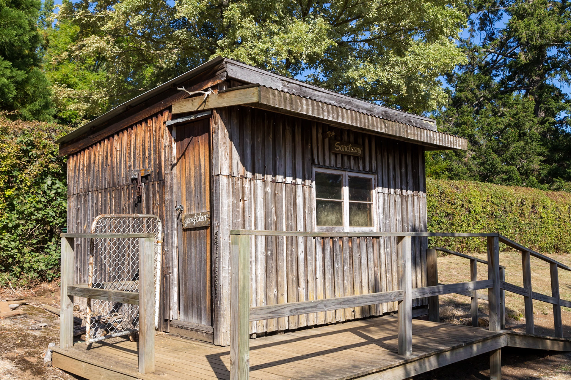 'The Sanctuary' fishing shack. A prime example of the many shacks built near lakes and streams throughout the state over the past century. This one was built in about 1947, constructed from the wood of packing crates used to bring car chassis over from the mainland.  At SALMON PONDS Heritage hatchery and gardens.