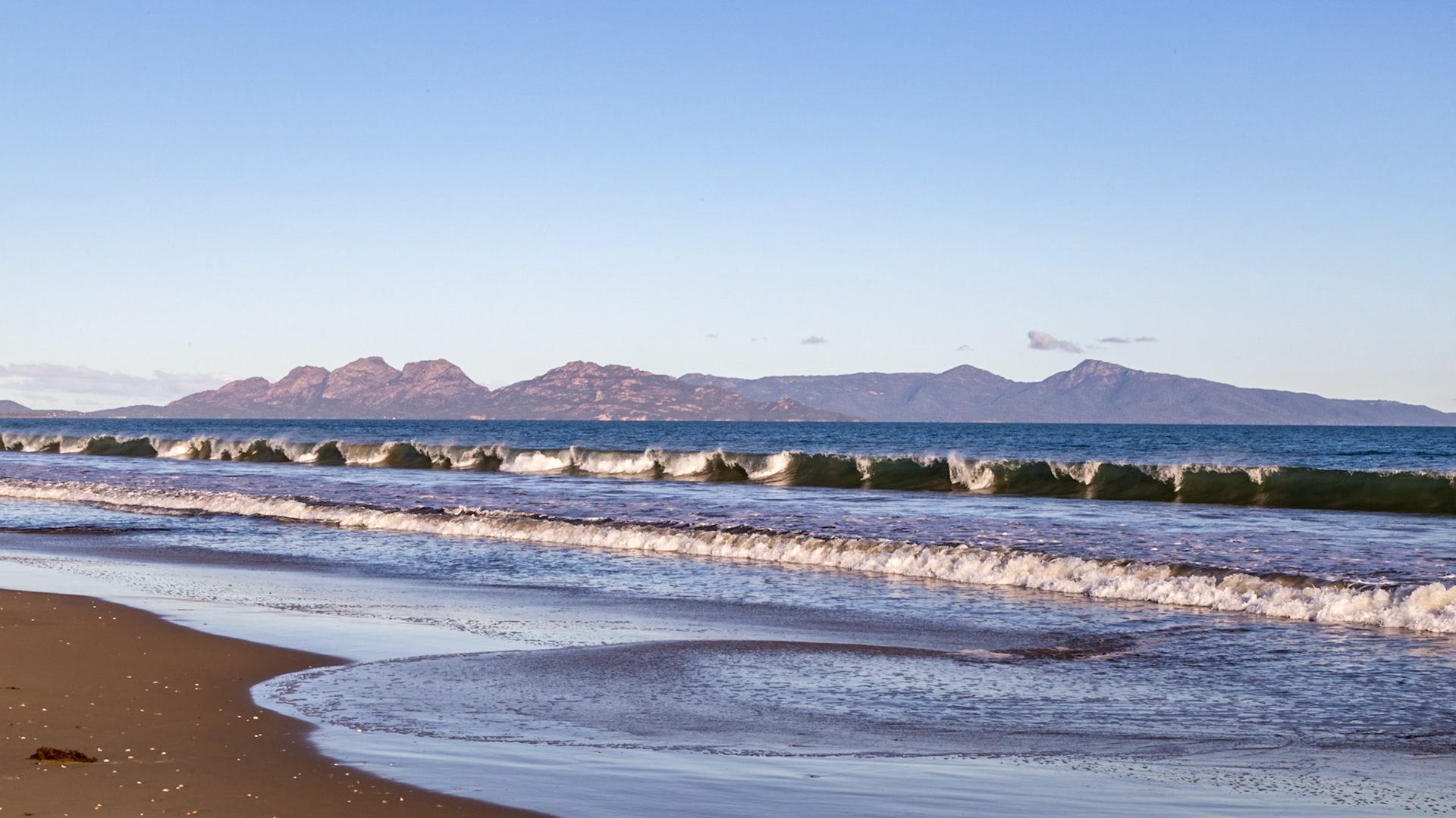 Freycinet Peninsula, in view from Nine-Mile Beach. Profiiles of the 5 peaks of 'The Hazards', then Mt Graham and Mt Freycinet, across Great Oyster Bay.
