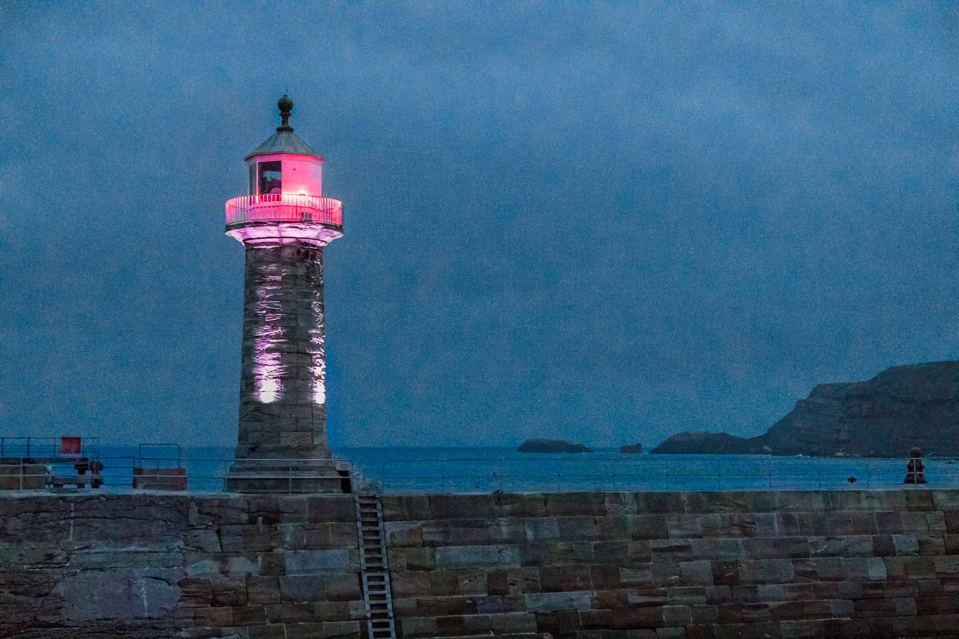 Whitby harbour light, early evening.