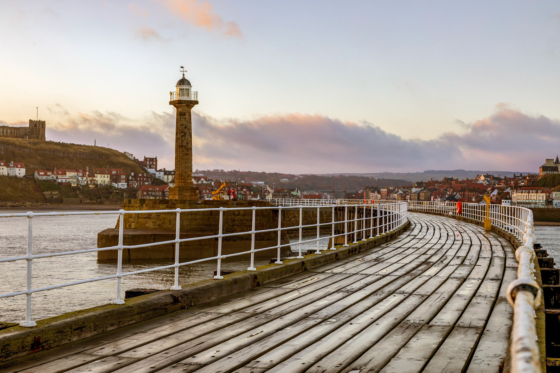 Sunrise on the promenade deck above the Whitby Harbour breakwater.