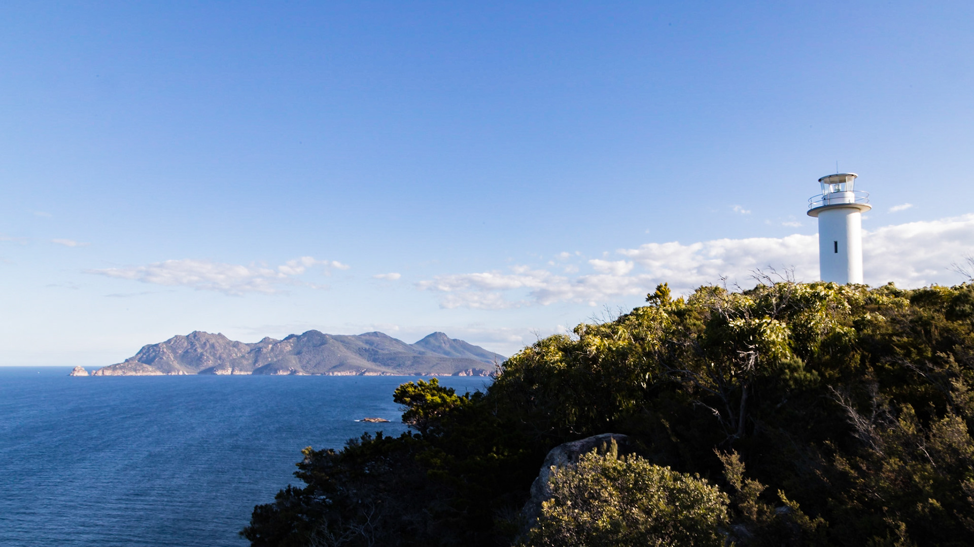 Cape Tourville Lighthouse. Mt Graham (579m) and Mt Freycinet (620m) in the background.