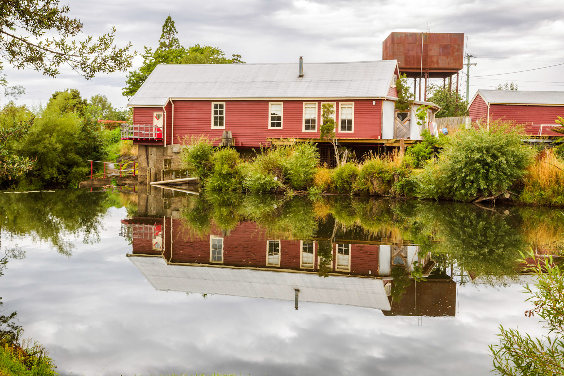 Deloraine, Reflection of the old power station building in the water of the Meander River.