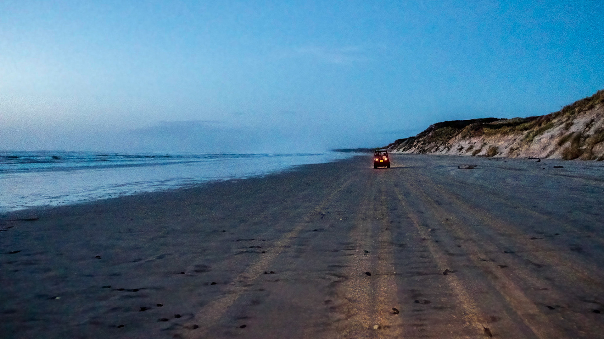 Ocean Beach (after sun down). Riding an ATV from Macquarie Head to the Ocean Beach car park near Strahan. With Strahan ATV Adventures
