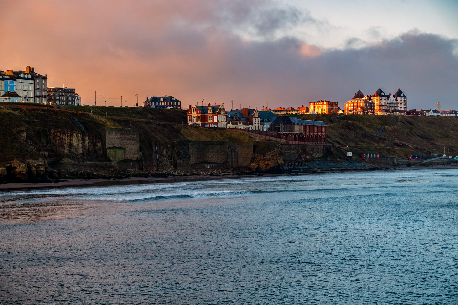 Early morning light shining on buildings on the eastern cliff side of the town of Whitby