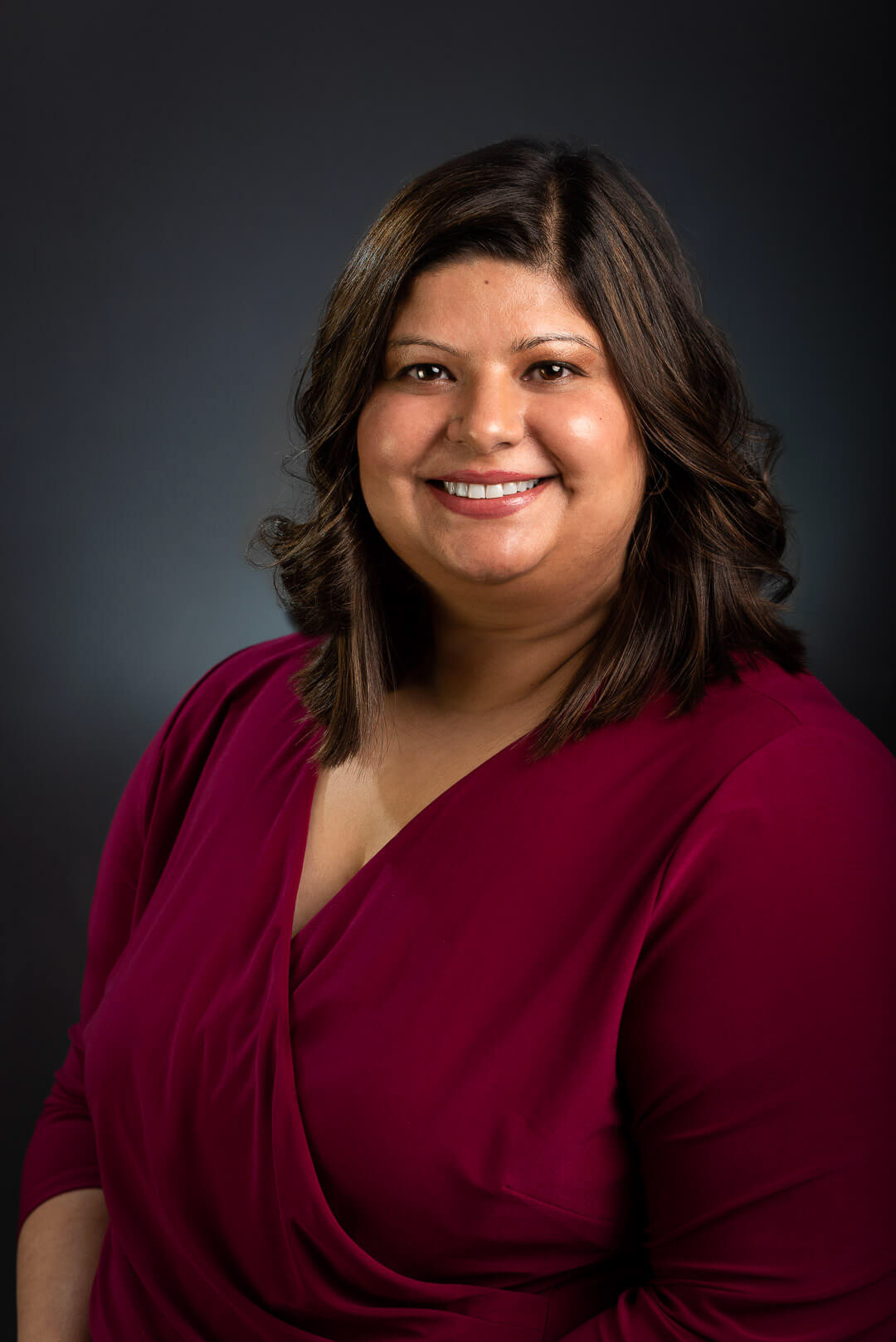 business photo, headshot, portrait, maroon dress, hair highlights