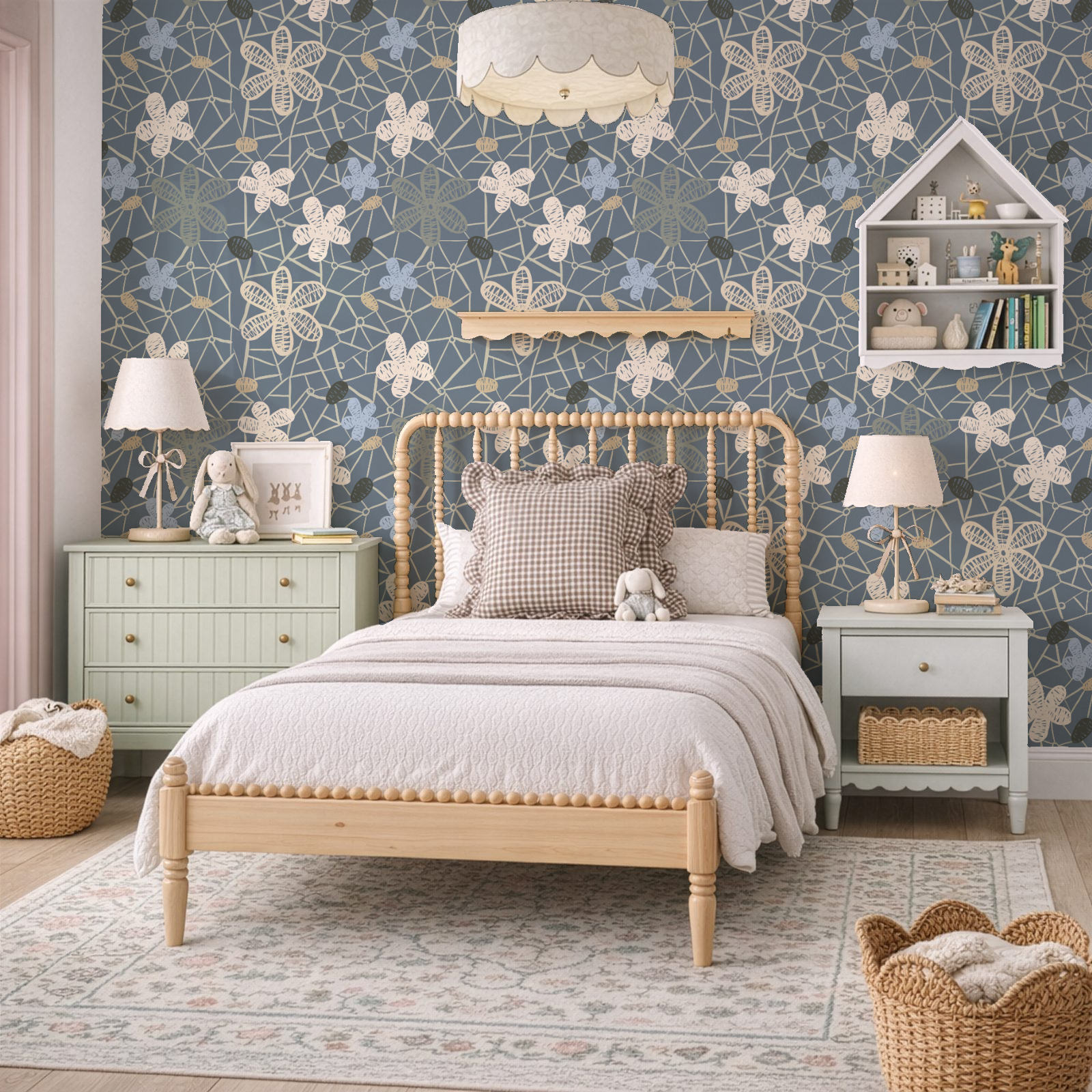 Children’s bedroom featuring blue and cream floral wallpaper behind a wooden spindle bed with neutral bedding, pastel nightstands, lamps, toys, and woven baskets; a warm, cozy interior showcasing the wallpaper as the focal point.