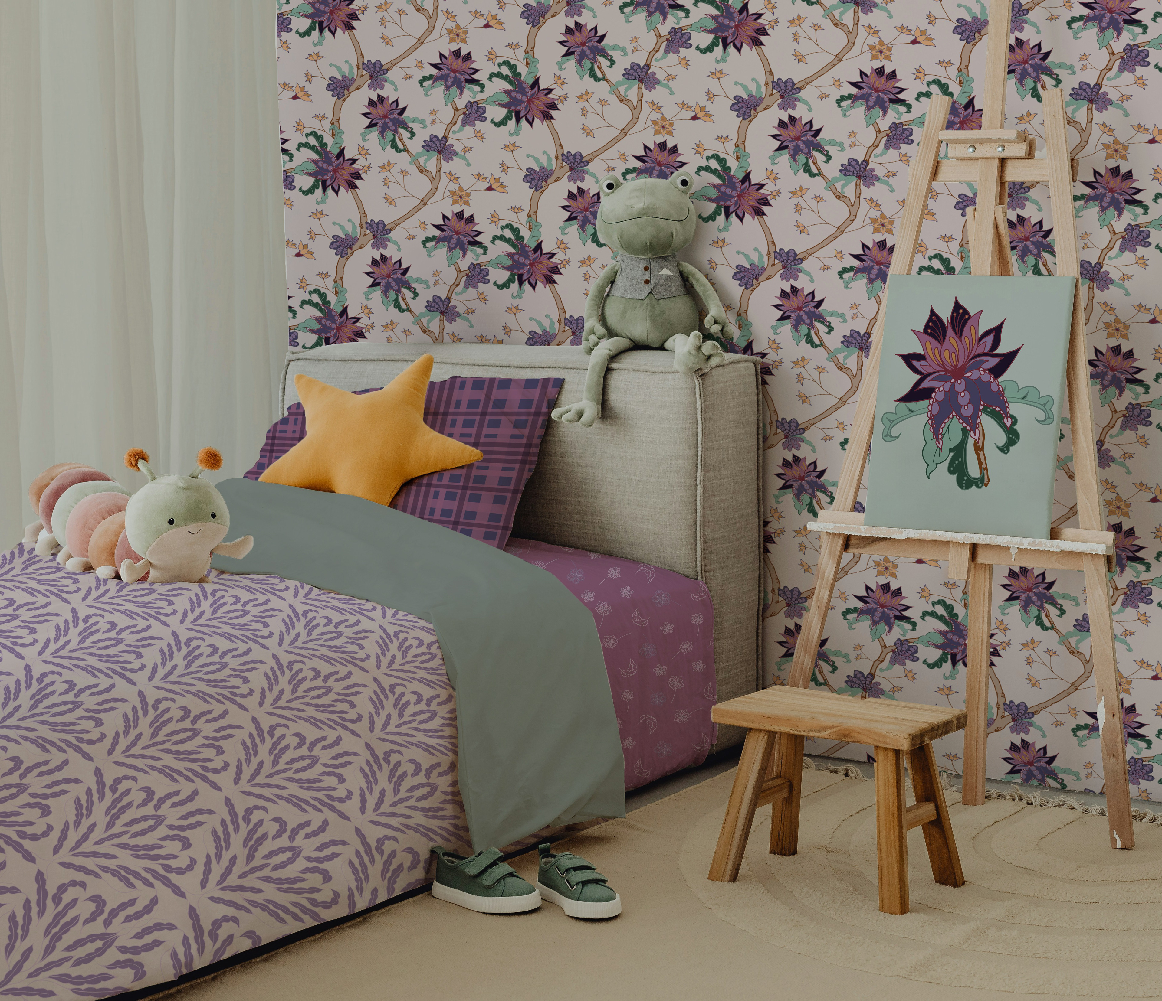 Children’s bedroom with Wandering Blossom floral wallpaper in soft purple tones, coordinated bedding, plush toys, and an art easel. A calm, nature‑inspired kids’ room showcasing botanical wallpaper and matching home décor.