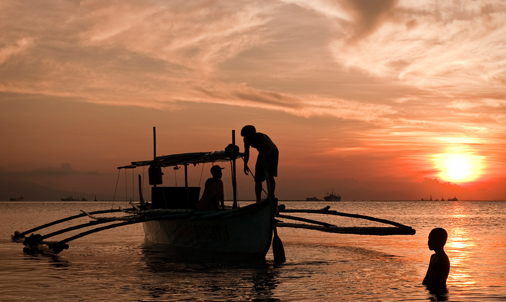 Boat on Manila Bay at sunset. 