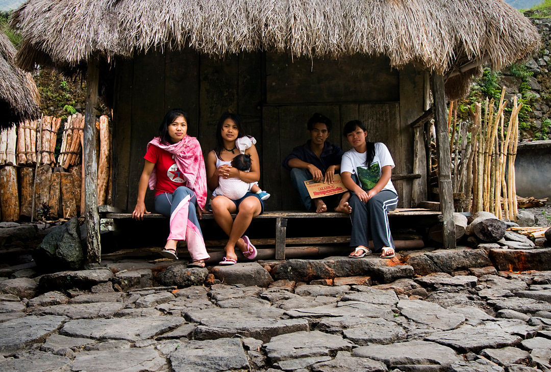 Boy and girls in a house in Batad village. 