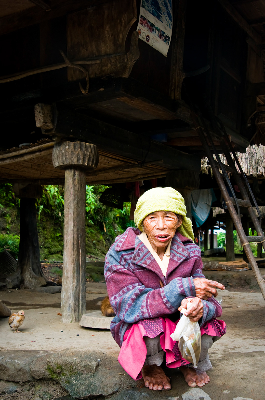 Old woman in front of his house in the village of Tam-an, near Banaue.