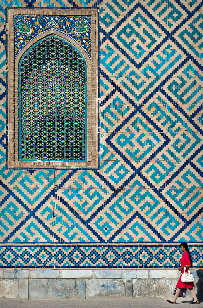   Samarkand. Woman walking beside the Registan walls. 