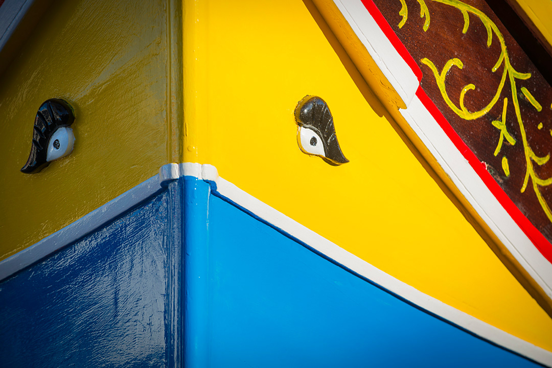 Traditional fishing boat (Luzzu) in Marsaxlokk harbour painted in colors with the Osiris eyes to keep evil spirits away. 