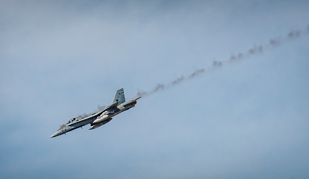 Spanish McDonnell Douglas F18 Hornet shooting its gun in Bárdenas shooting range.