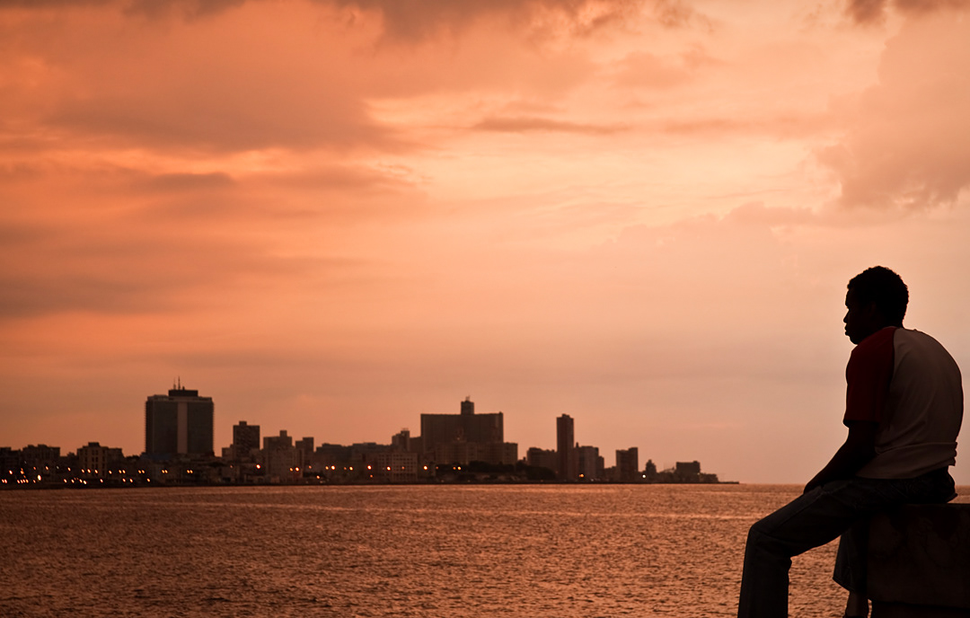 Dusk in Malecon. Lots of young people reckon that emigration is the only way to scape of the problems of the county. 