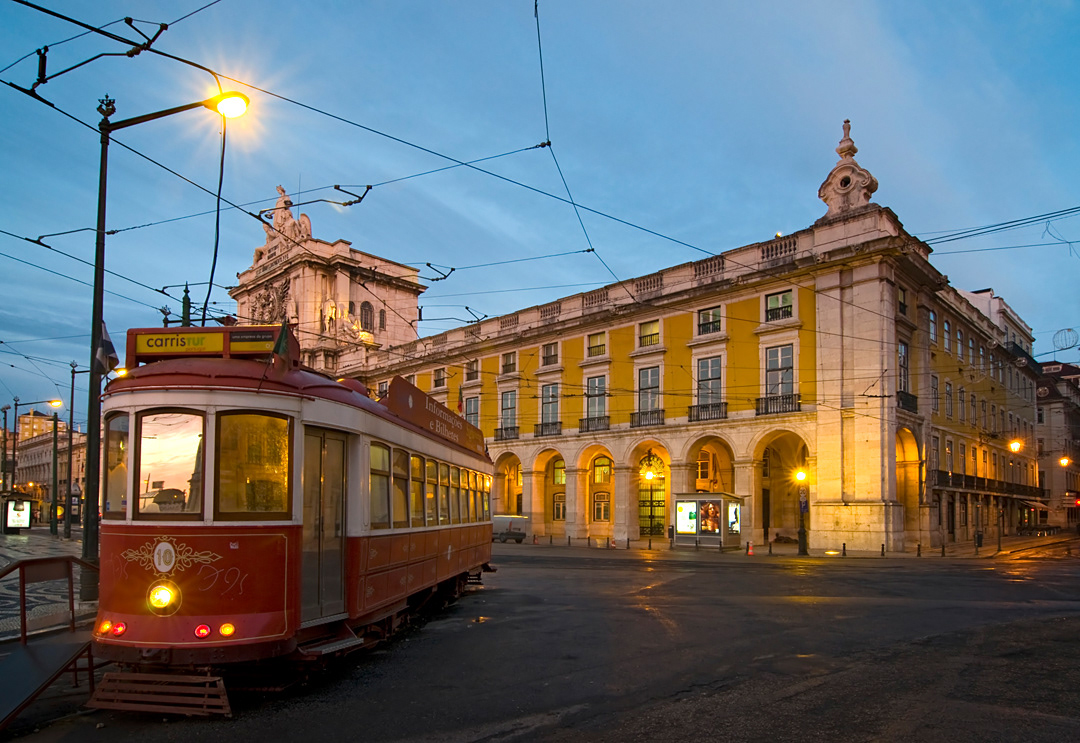 Tram at the Comercio scuare in Lisbon at dawn. 