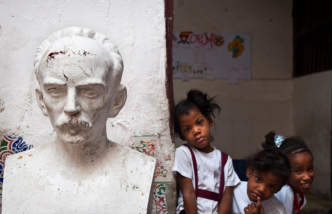 Children with a bust of Jose Marti at a primary school in Old Habana. Free education is one of the major developments in Cuban society. 