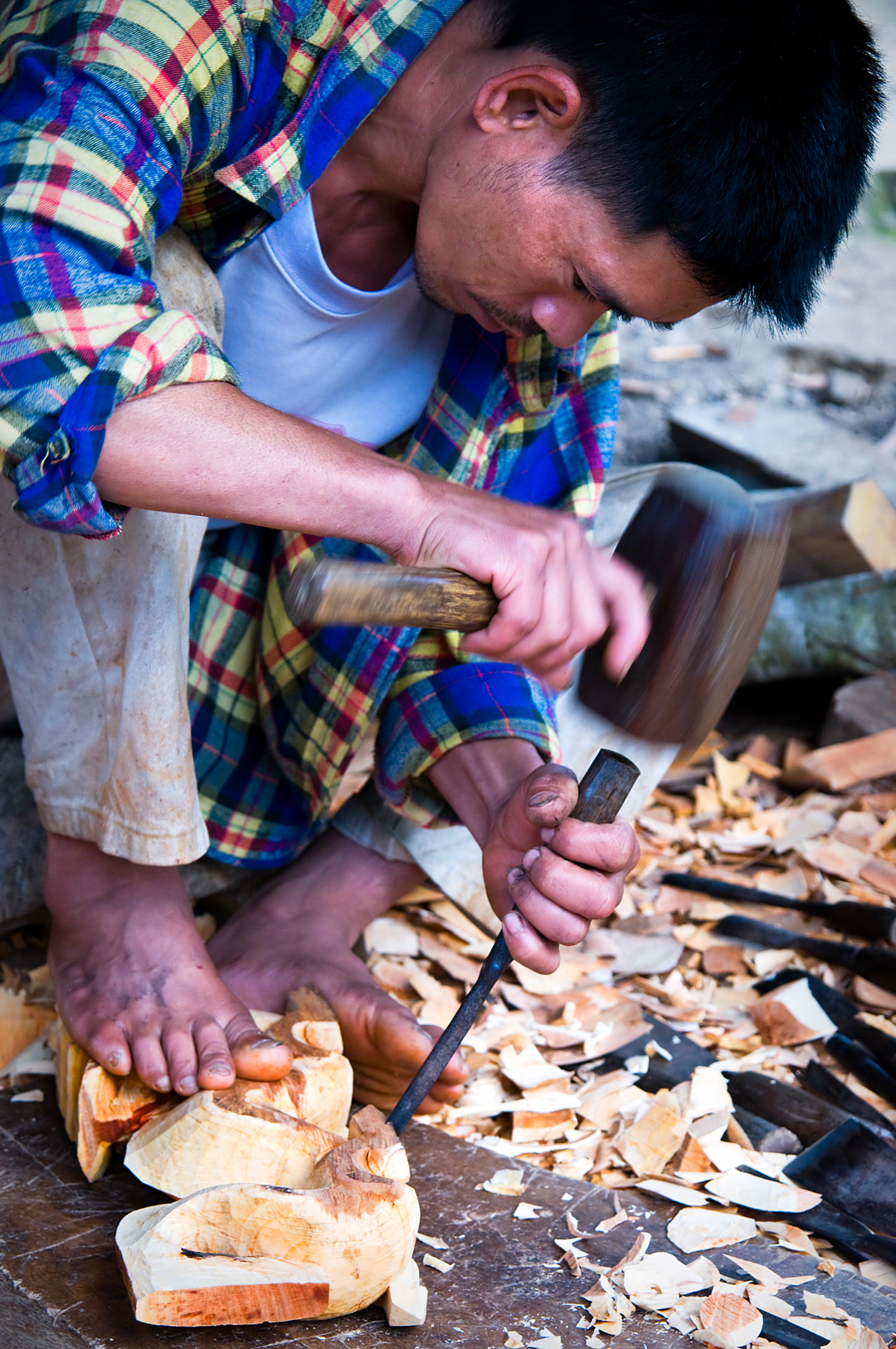 A man carving wood in the village of Bocos, near Banaue. 