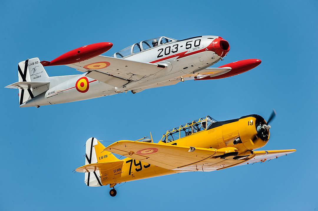 HA-200 Saeta and North American T6 Texan from the Fundación Infante de Orleans during an air show at the Cuatro Vientos airfield in September 2012.