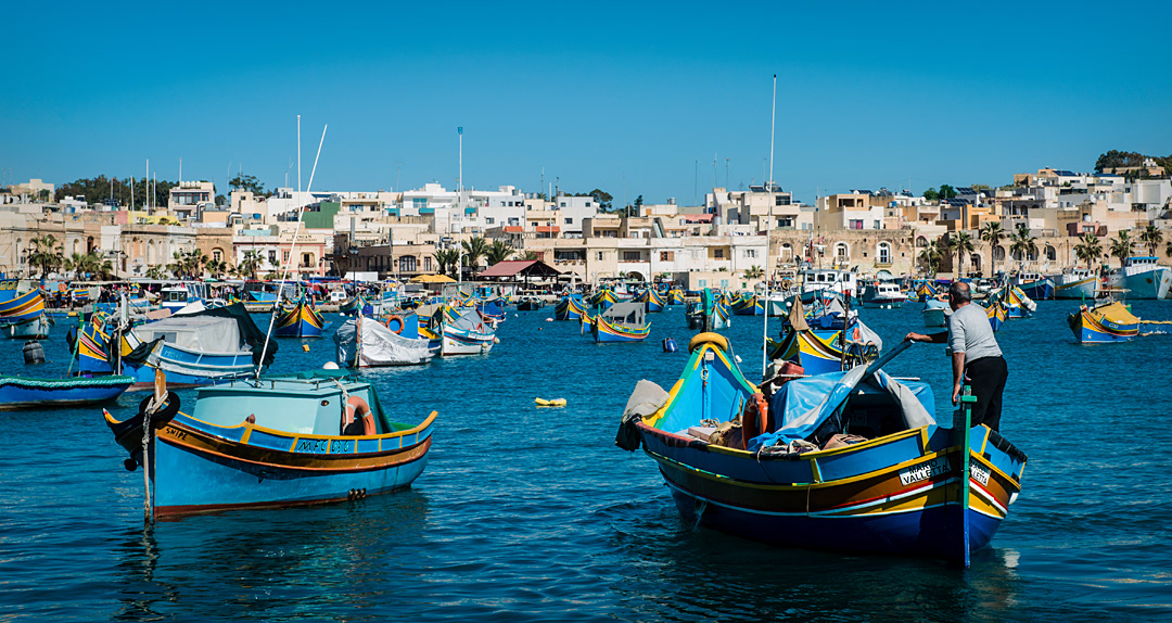 A traditional fishing boat (Luzzu) arriving at Marsaxlokk's harbour. 