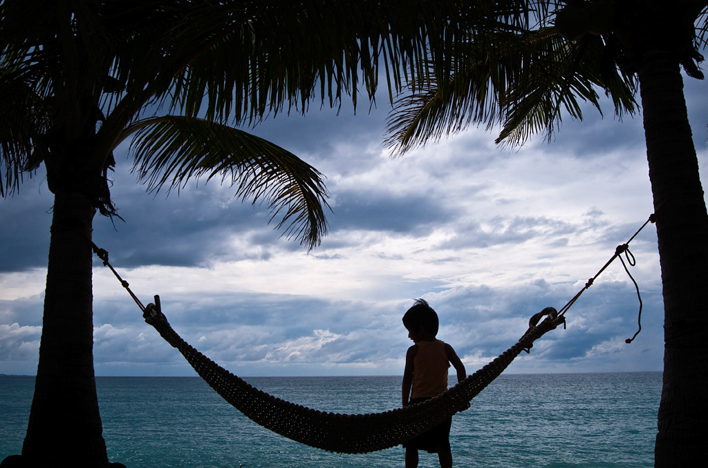 Pagudpud. Boy playing with a hammock in a resort. 