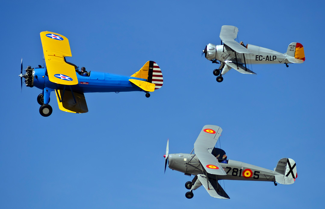 A formation of three biplanes from the Fundación Infante de Orleans in an air show at the Cuatro Vientos aerodrome (Madrid).