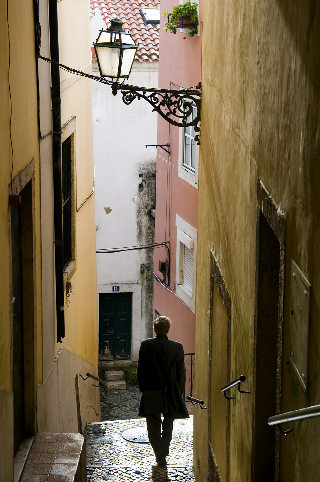 A man in the old streets of the Alfama in Lisbon. 