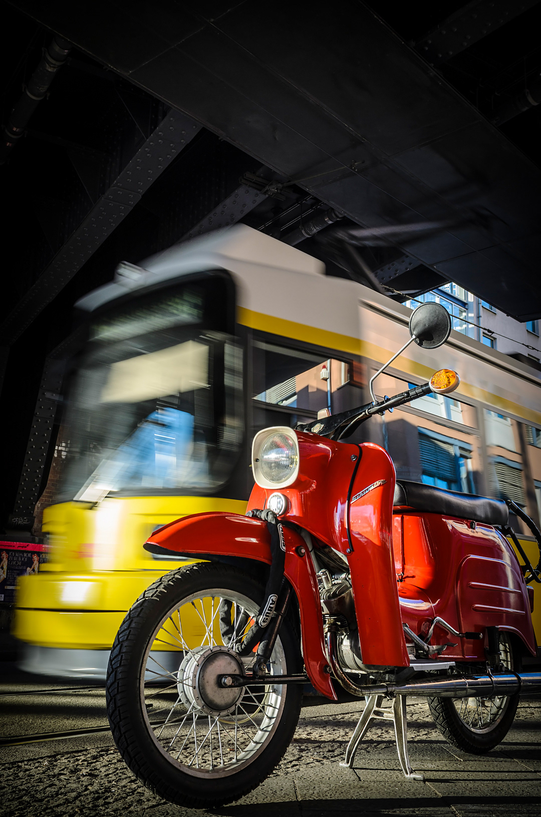 Motorbike and tram under a S-Bahn station.
