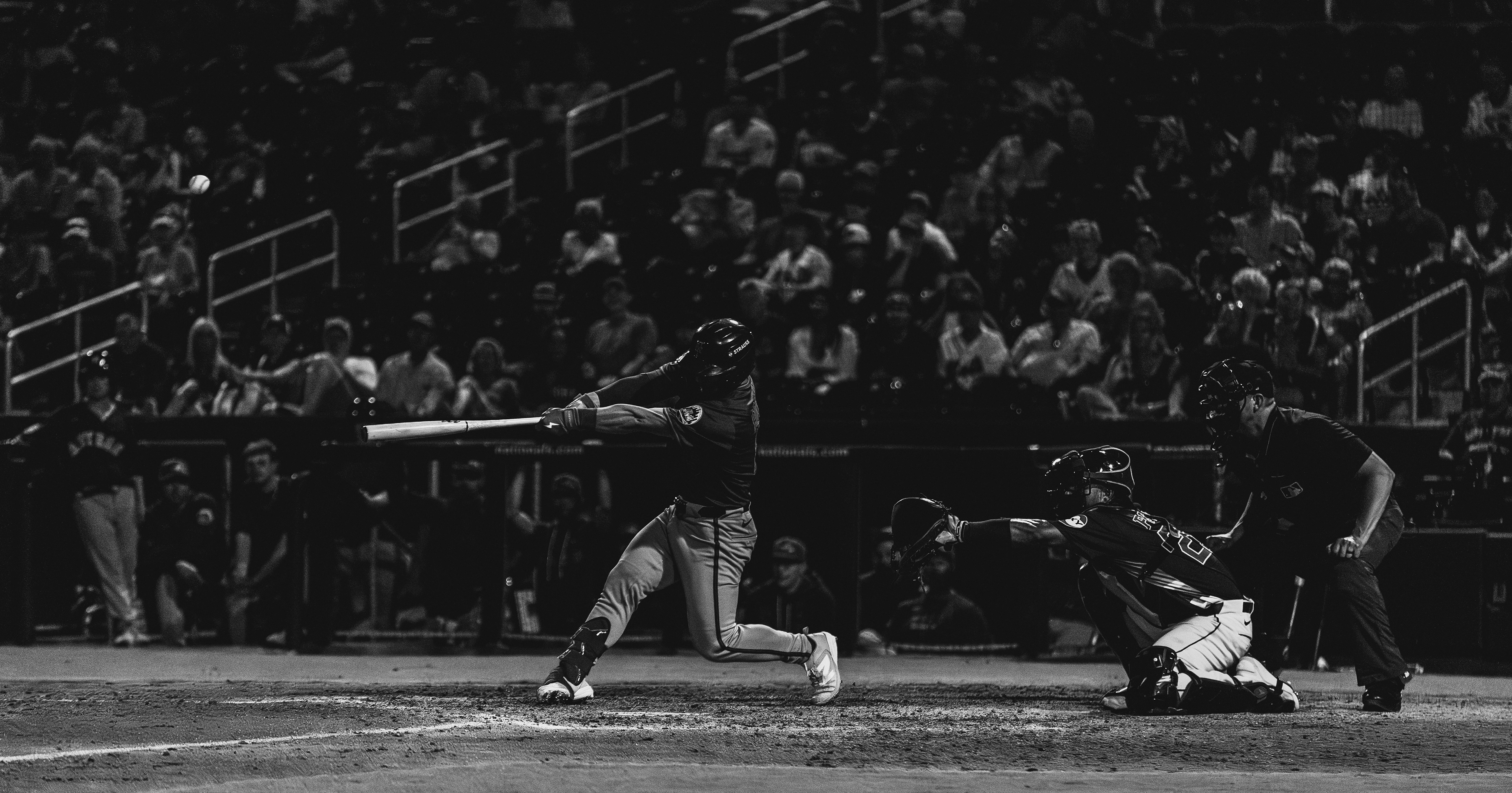 New York Mets batter swings and connects during a spring training night game against the Houston Astros at The Ballpark of the Palm Beaches, March 2026. Black and white edit. Photo by Aday's Media Production