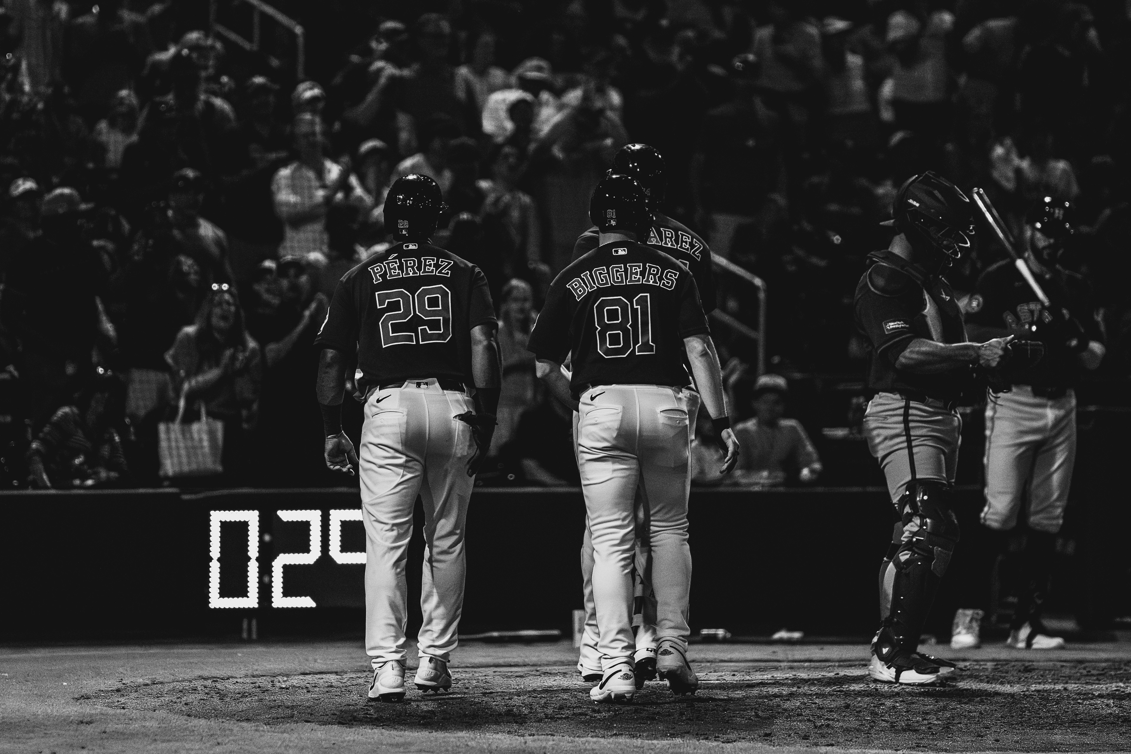 Carlos Perez (29) and Jax Biggers (81) of the Houston Astros walk off the field during a spring training game against the New York Mets at The Ballpark of the Palm Beaches, March 2026. Black and white edit. Photo by Aday's Media Production