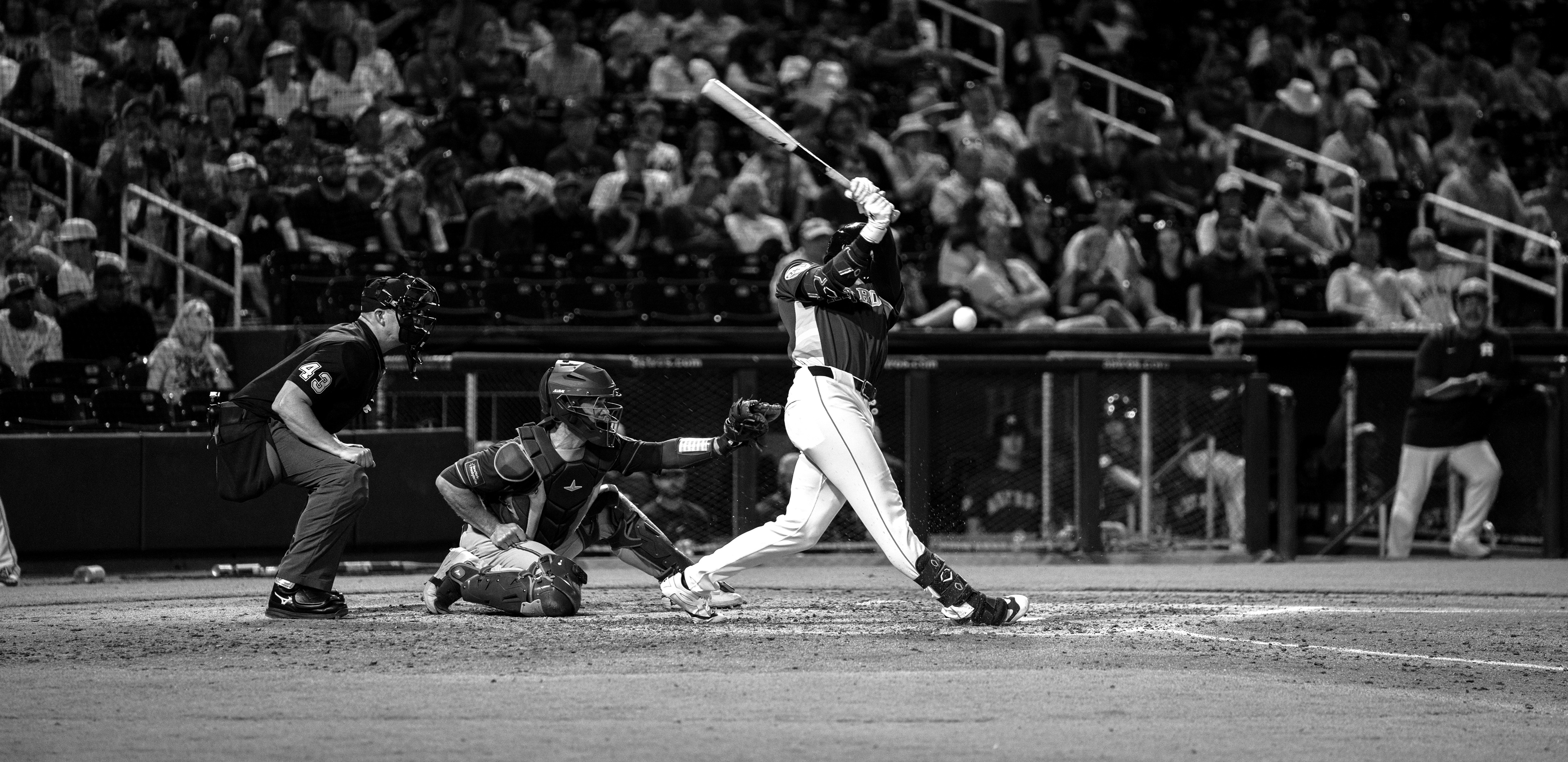 Houston Astros batter follows through on a swing against the New York Mets during spring training at The Ballpark of the Palm Beaches, March 2026. Black and white edit. Photo by Aday's Media Production