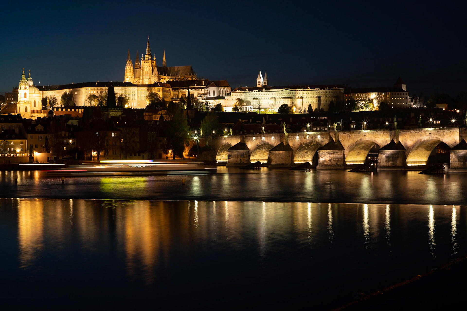 The old Prague castle and Charles Bridge at night. The castle is not only very large but has also been the place for a number of important historical incidents.