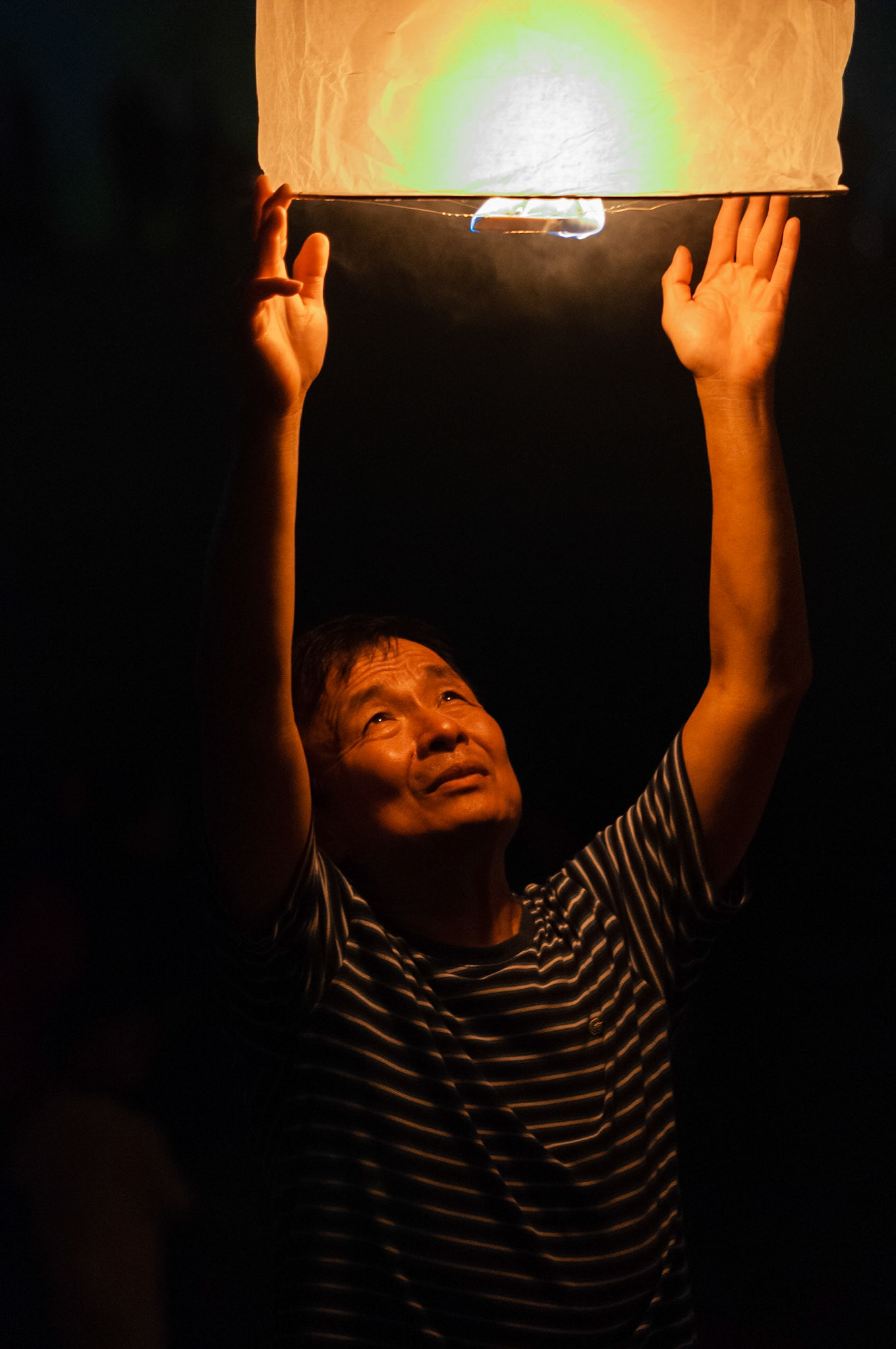 As darkness falls, people gather to make personal offerings of sky lanterns, made using traditional methods of wrapping bamboo frames with oiled rice paper. These act as a memorial to the ancestors and deliver wishes to the heavens as the lanterns float luminously into the sky.