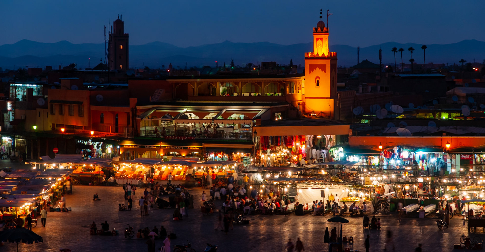 The night market in Marrakech's Jemaa el-Fna Medina teems with snake charmers, folk dancers and street vendors serving all manner of food, from tagines to camel heads. The Mosque's minaret keeps watch with its ethereal glow and the heady spell of spices float though the air. Built in around 1000 AD, UNESCO has declared the market a "Masterpiece of the Oral and Intangible Heritage of Humanity" due to its contiguous use by traditional storytellers, musicians and performers.
