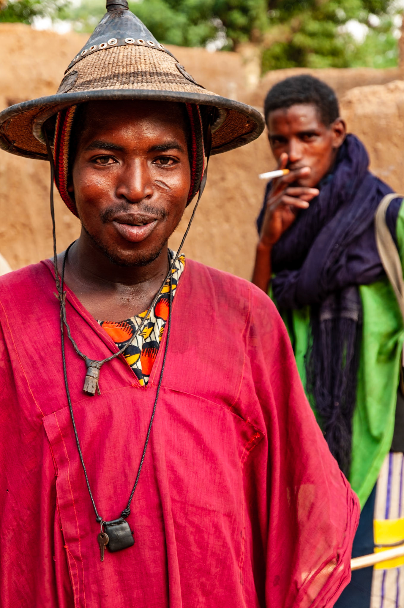 The Dogon are a people living in the central plateau region of Mali. One of Africa’s most isolated ethnic groups, they were virtually unheard of in the West until the early 1930s. Now, they have one foot in the past and one in today - a young man wears traditional dress while his friend closeby smokes a Marlboro cigarette.