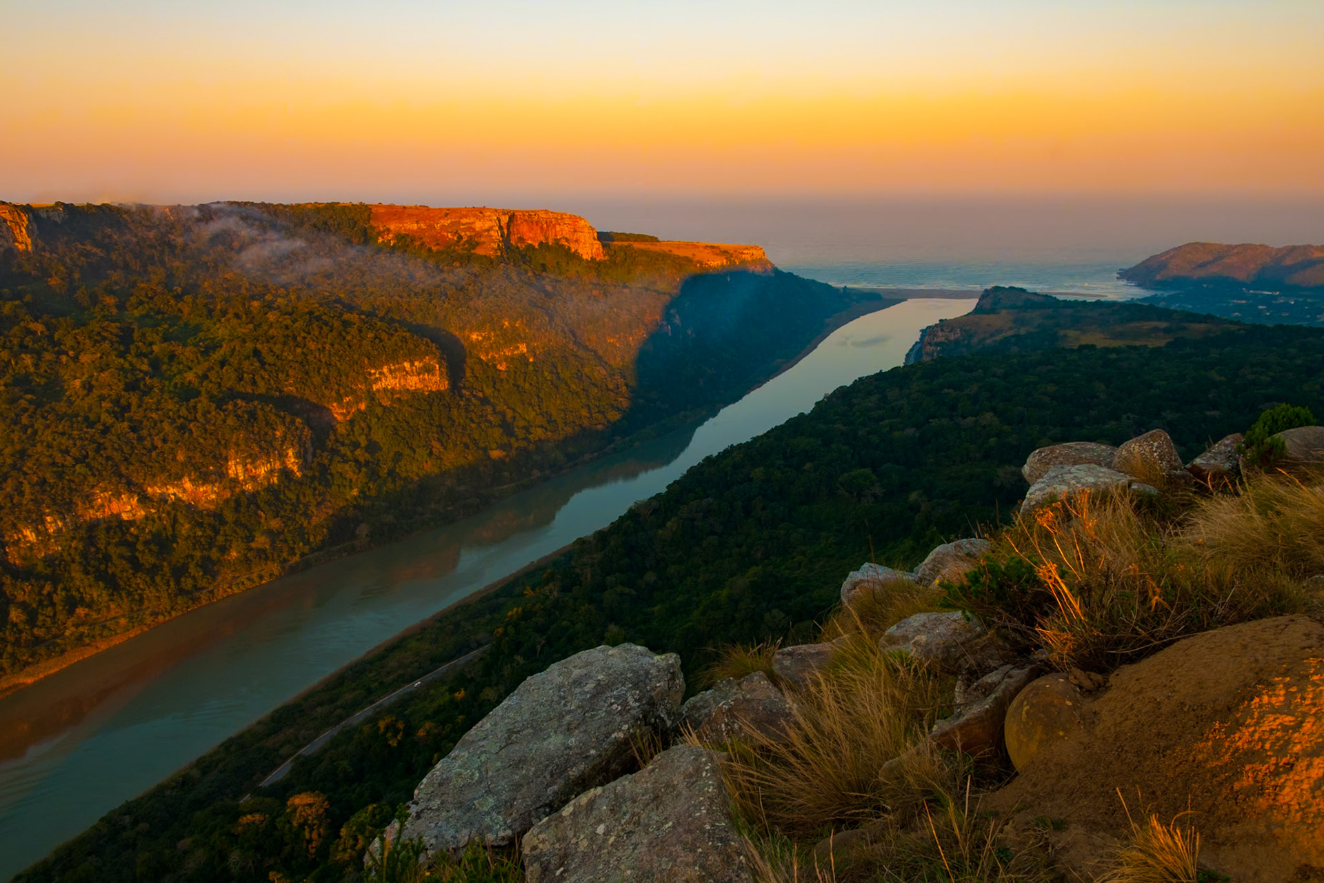 The Gates of St. John are formed by the steep sandstone cliffs of Mount Sullivan and Mount Thesiger on either side of the Mzimvubu River at Port St. Johns. The port is located on South Africa's Wild Coast, which has a wild reputation. Sudden storms, wild winds, heavy seas and the occasional freak wave have claimed many ships. Port St. Johns is named after the wreck of the 16th century Portuguese ship Sao João.