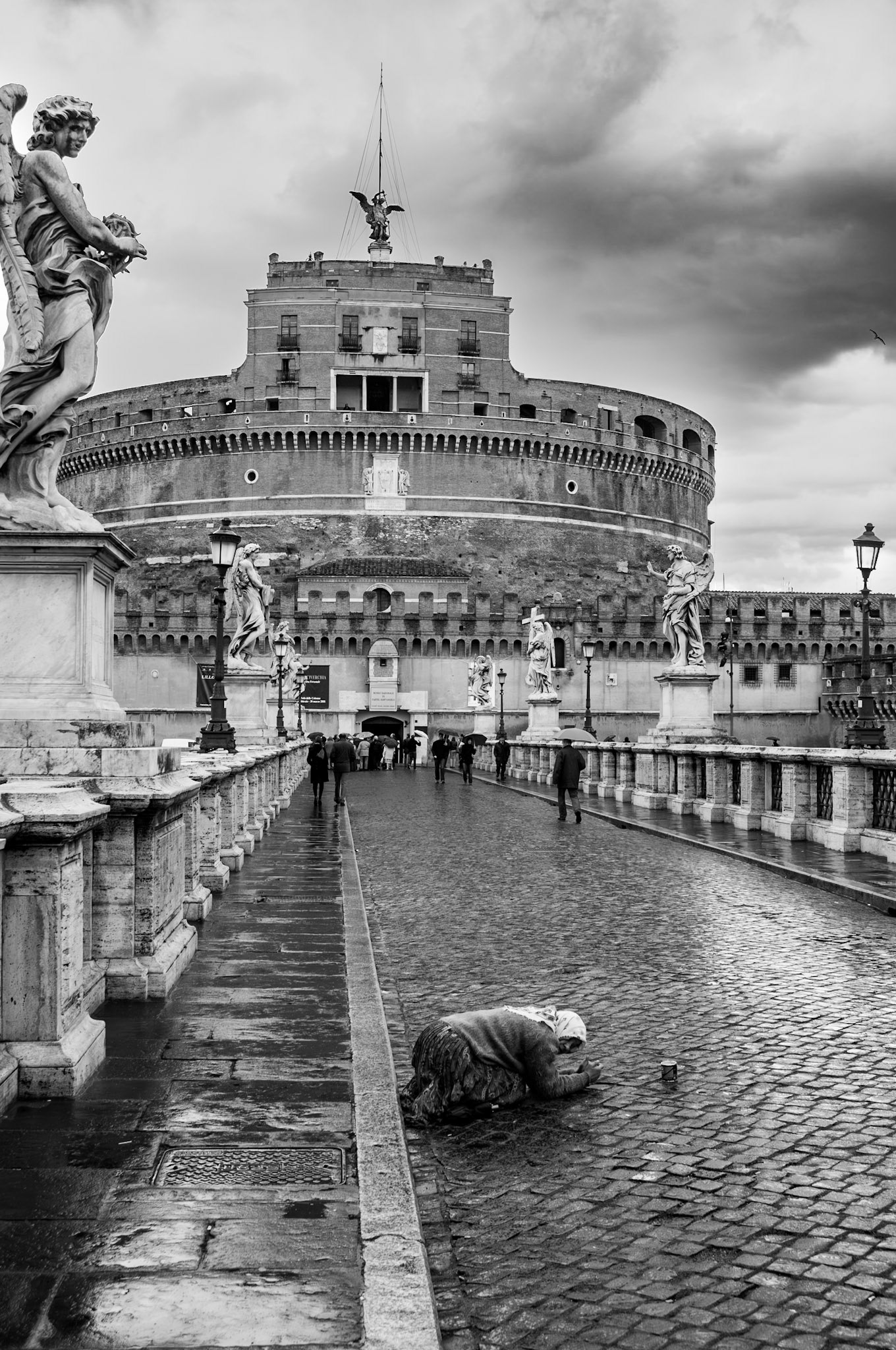 Disinherited: A desperate woman prostrates herself to beg on a near-empty bridge in the Vatican City.