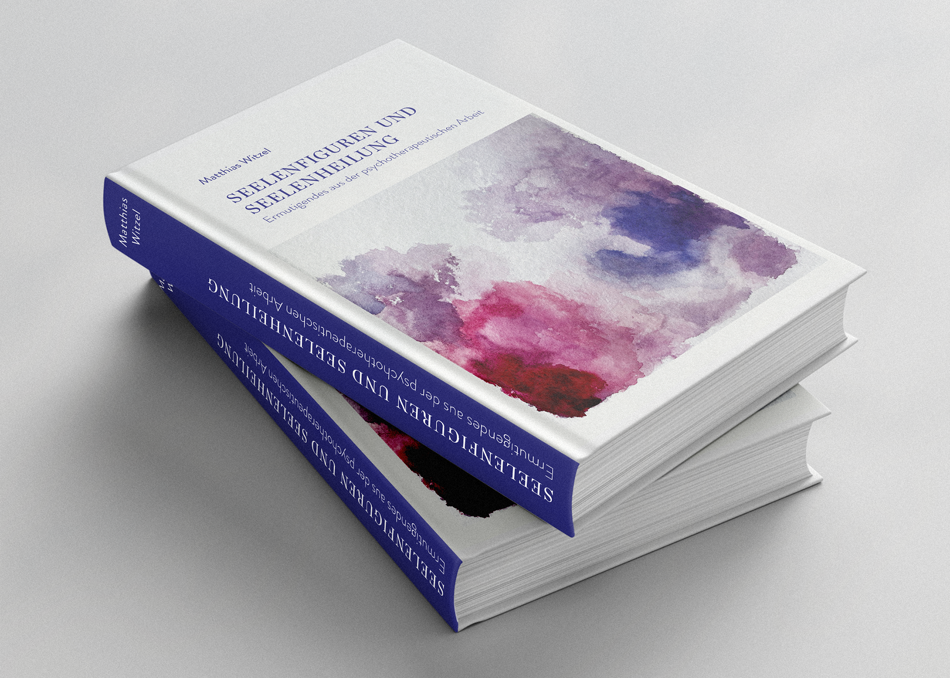 Zwei Bücher mit dem Titel "Seelenfiguren und Seelenheilung - Ermutigendes aus der psychotherapeutischen Arbeit" von Matthias Witzel übereinander gestapelt, auf dem Cover ist eine Abstrakte Aquarellzeichnung.