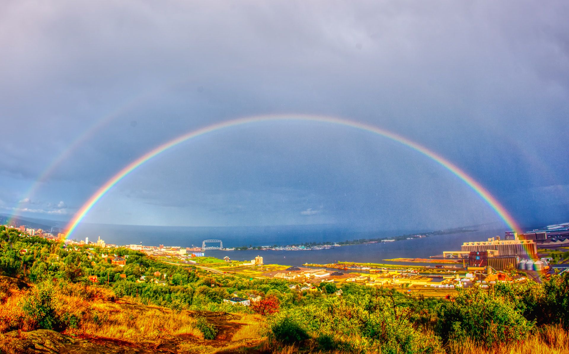 August 1st—Through the Looking Glass—This late afternoon rainbow over Duluth Harbor lasted for a few minutes yet caught your attention in an episode of awe.Rainbows are beautiful representations of hope and a promise from God to put your trust in Him.Hold unswervingly to the hope we profess, for he who promised is faithful. Hebrews 10:23