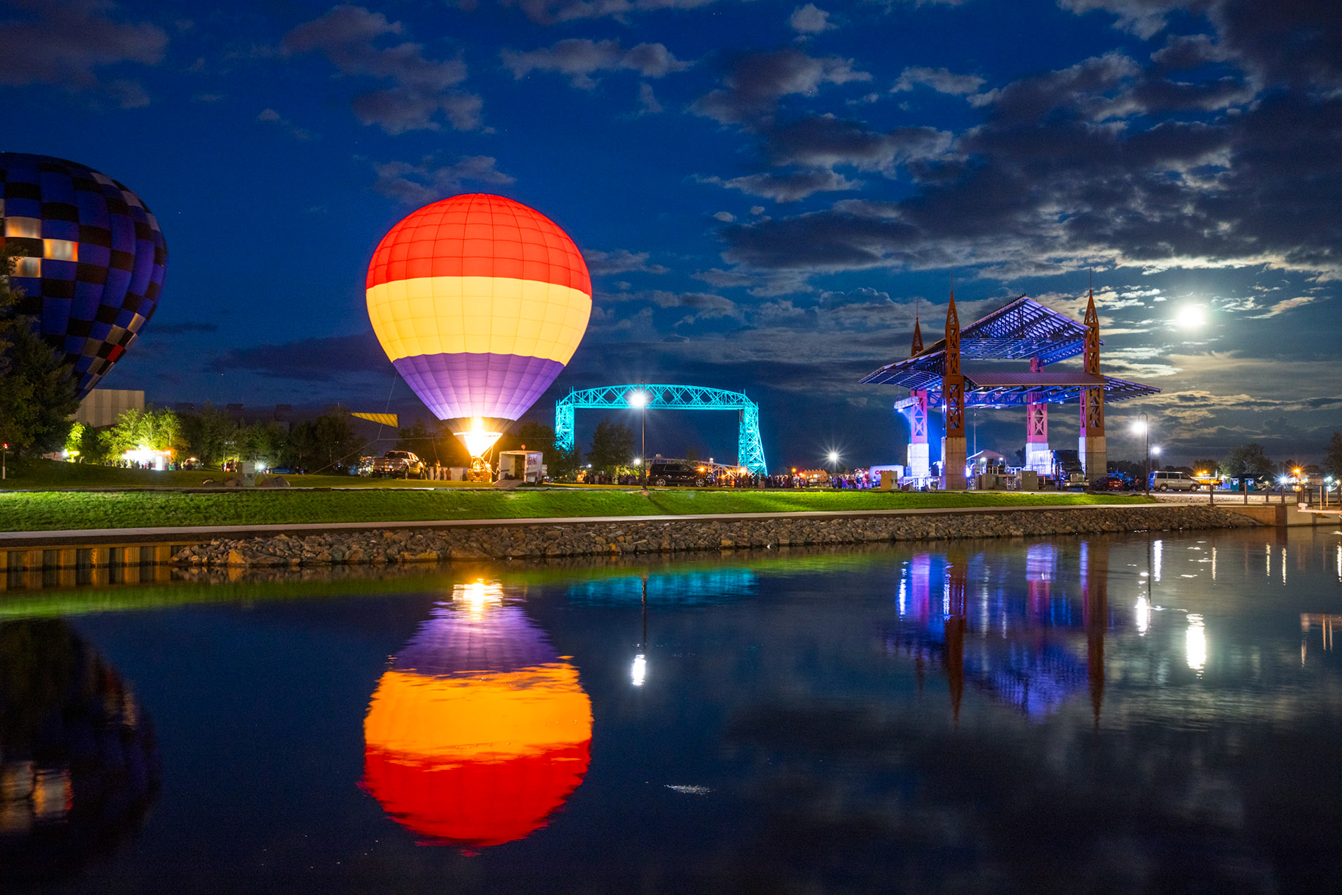 September 13th - Colored Bayfront -  September is a time of festivals and celebrations, a vibrant contrast to the impending winter. It is a time to thank God for the harvest and prepare for the colder months. These balloons are a beautiful attraction, but the reflections added by moonlit reflections are even better.Ecclesiastes 3:1-8 (NIV) - "There is a time for everything, and a season for every activity under the heavens: a time to be born and a time to die, a time to plant and a time to uproot, a time to kill and a time to heal, a time to tear down and a time to build, a time to weep and a time to laugh, a time to mourn and a time to dance, a time to scatter stones and a time to gather them, a time to embrace and a time to refrain from embracing, a time to search and a time to give up, a time to keep and a time to throw away, a time to tear and a time to mend, a time to be silent and a time to speak, a time to love and a time to hate, a time for war and a time for peace."