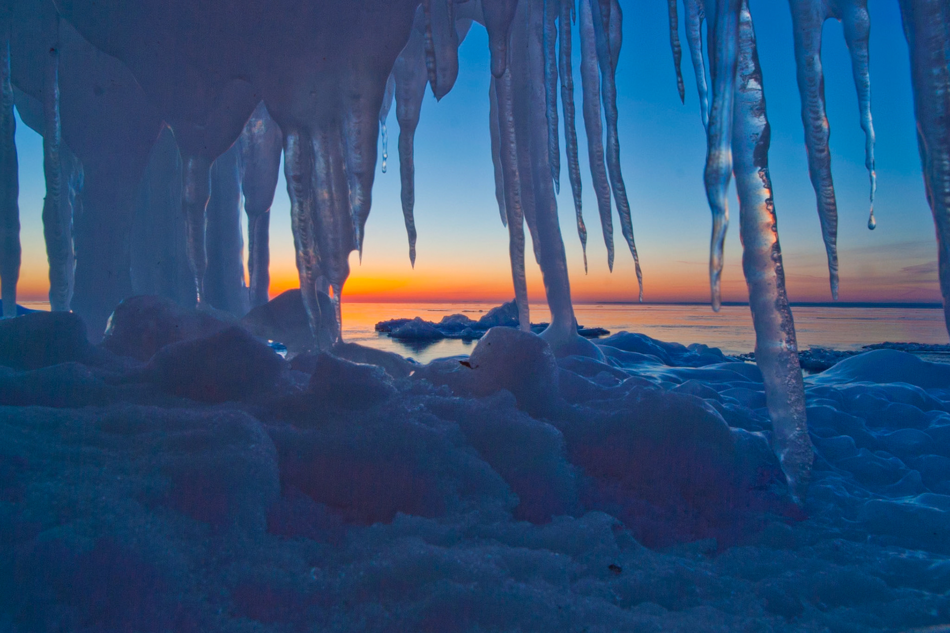 Icy Sunrise - icicles overhanging Lake Superior Shoreline.